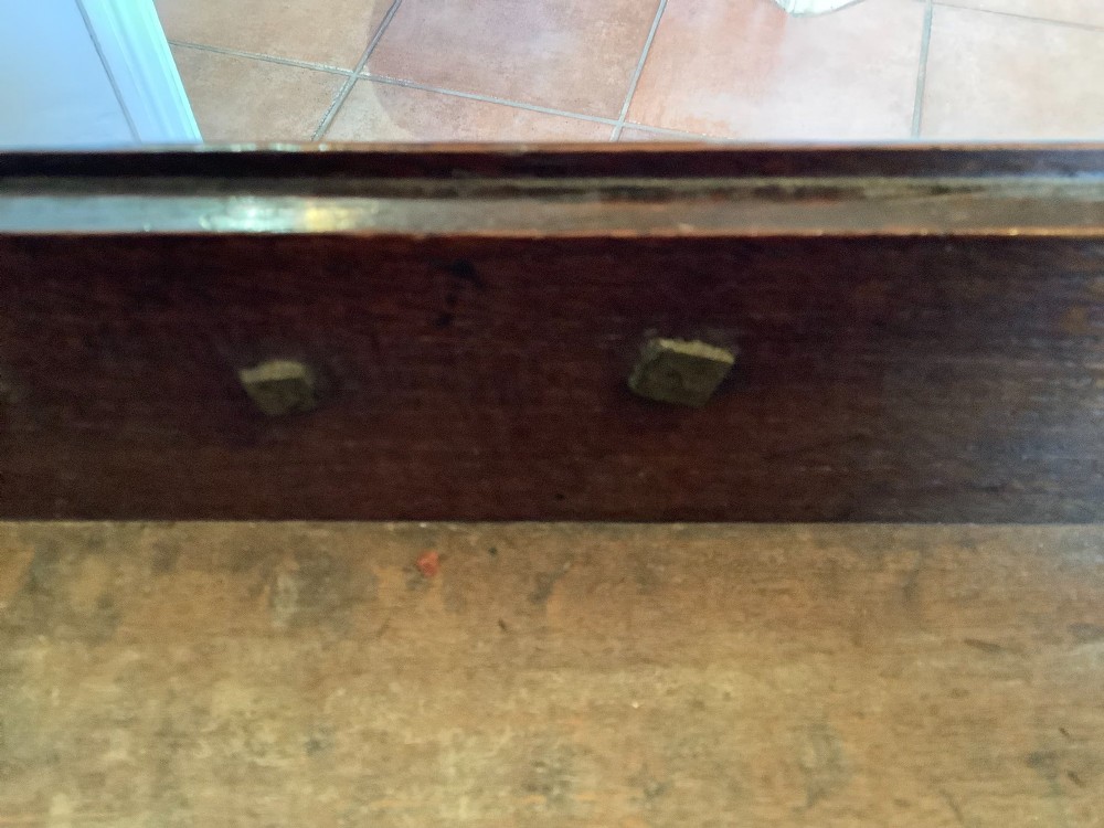 An 18th-century oak lowboy featuring a three-drawer configuration above an arched apron and cabriole legs ending in pad feet. View VIII