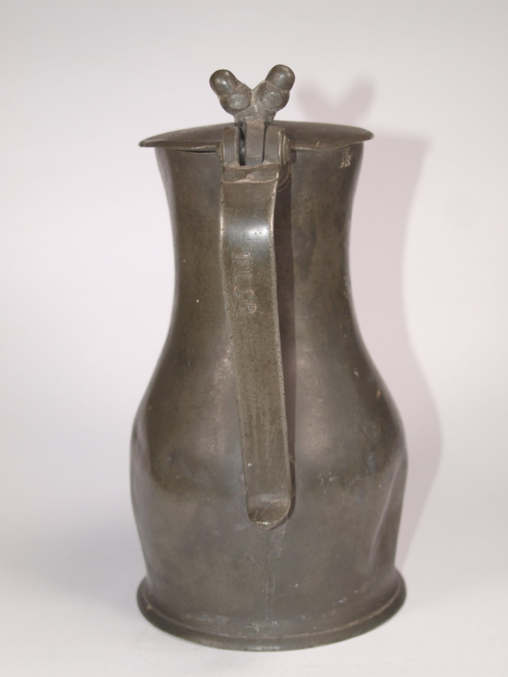 An antique slate grey pewter lidded quart measure featuring a baluster shape, attached strap handle, and hinged lid. View II