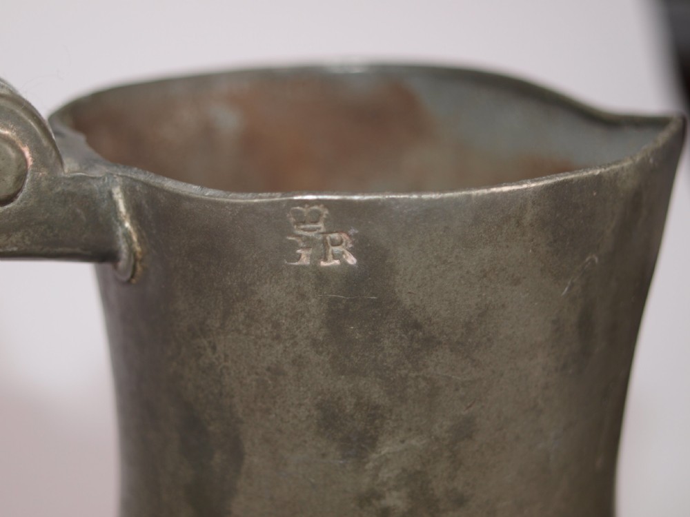An antique slate grey pewter lidded quart measure featuring a baluster shape, attached strap handle, and hinged lid. View XI