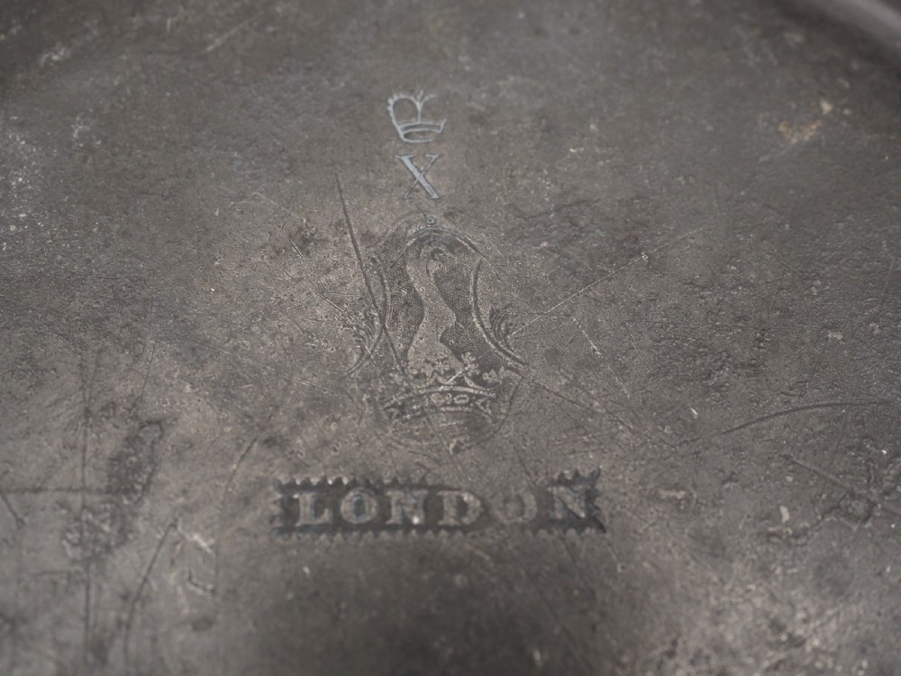 A circular grey antique pewter deep plate featuring a wide plain rim engraved with monogrammed initials at the top and the date 1845 at the bottom. View V