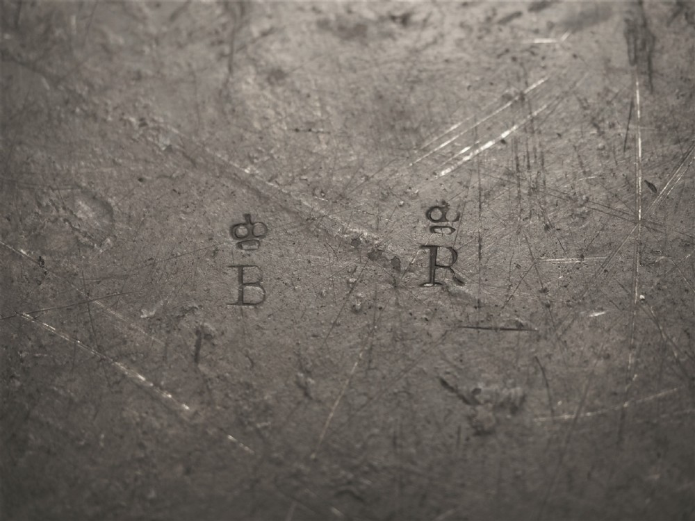 A circular 18th-century English pewter charger featuring a broad plain rim and an aged patinated surface. View VII