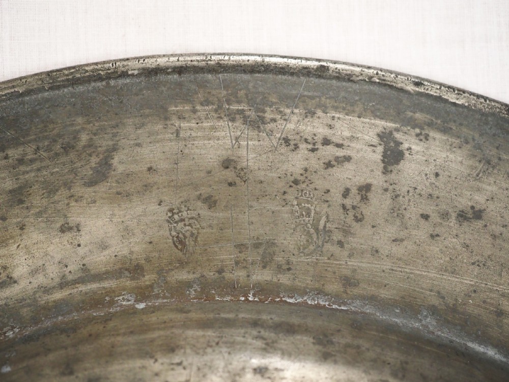 A circular late seventeenth-century grey pewter charger plate featuring a triple-reeded rim and hand-hammered surface finish. View IX