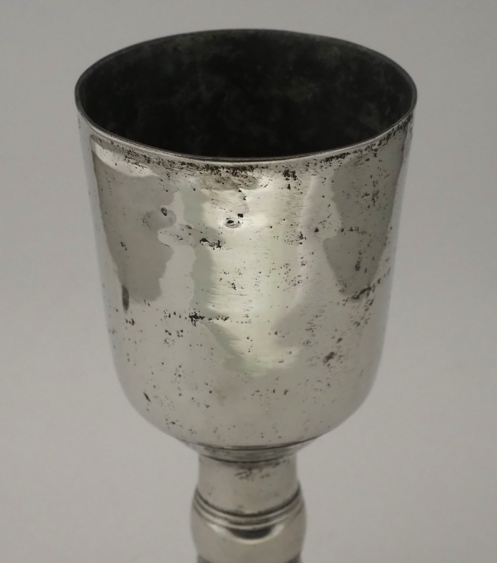 An antique Irish pewter chalice featuring a tall cylindrical bowl, a central knopped stem, and a stepped domed foot. View III