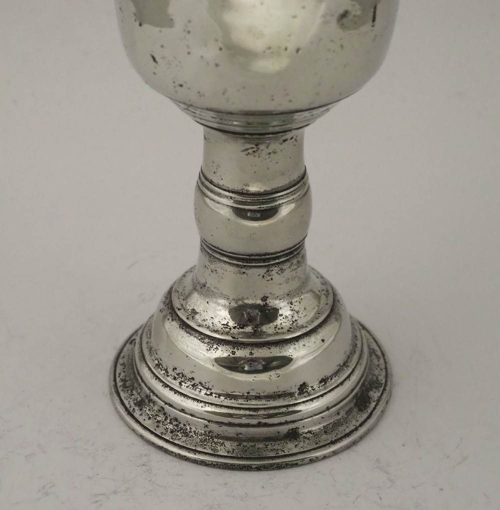 An antique Irish pewter chalice featuring a tall cylindrical bowl, a central knopped stem, and a stepped domed foot. View IV