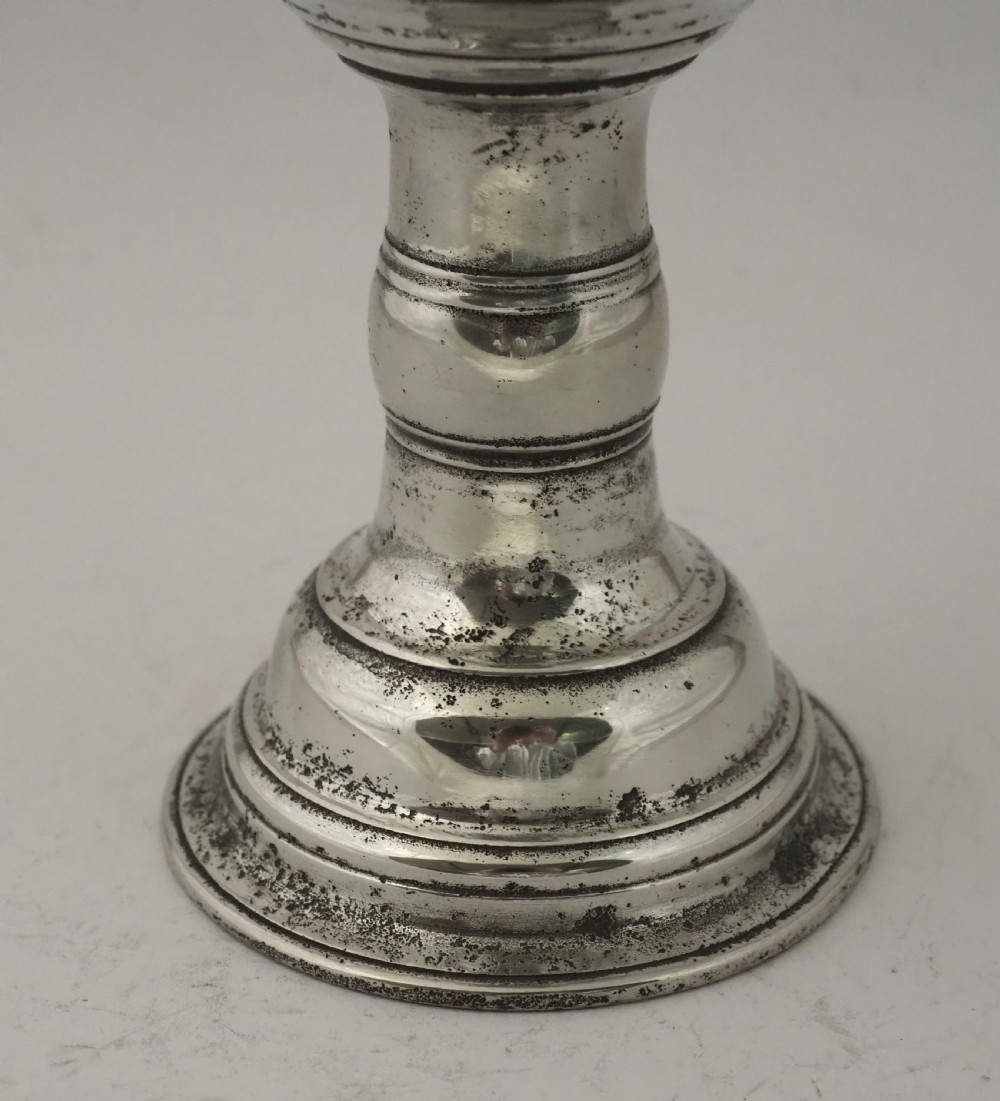 An antique Irish pewter chalice featuring a tall cylindrical bowl, a central knopped stem, and a stepped domed foot. View V