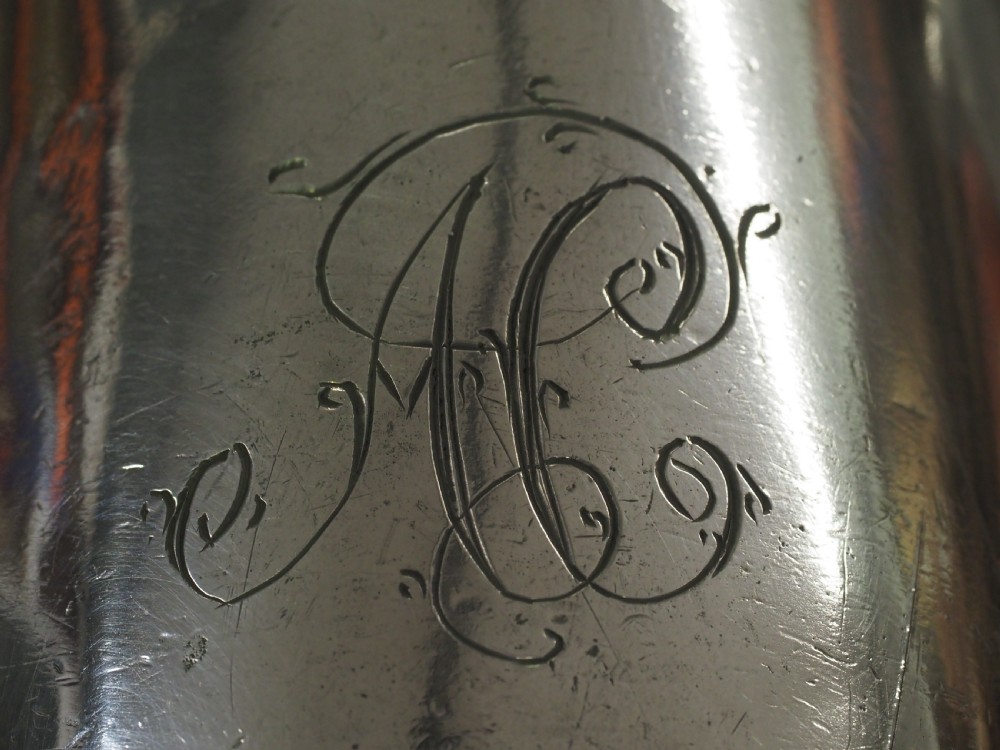 An 18th-century English pewter ale jug featuring a flared base, central girdle moulding, single poured spout, and curved handle. View XV