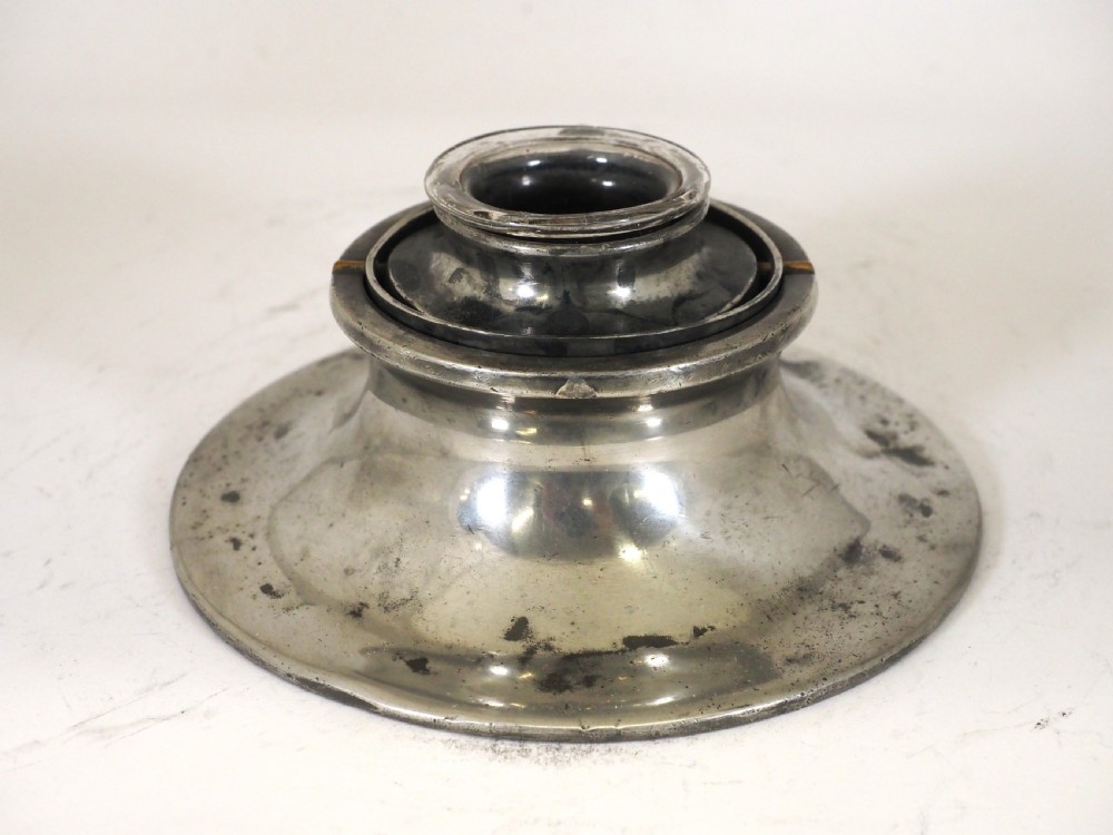 An antique pewter ships inkwell featuring a wide circular capstan base and a domed lid. View II