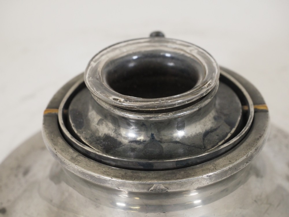 An antique pewter ships inkwell featuring a wide circular capstan base and a domed lid. View III