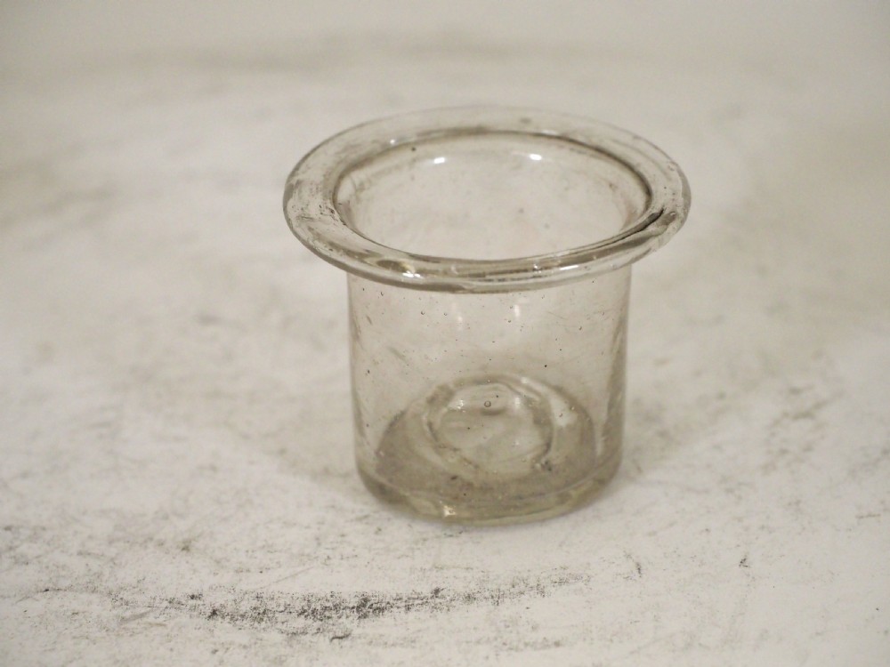An antique pewter ships inkwell featuring a wide circular capstan base and a domed lid. View IV
