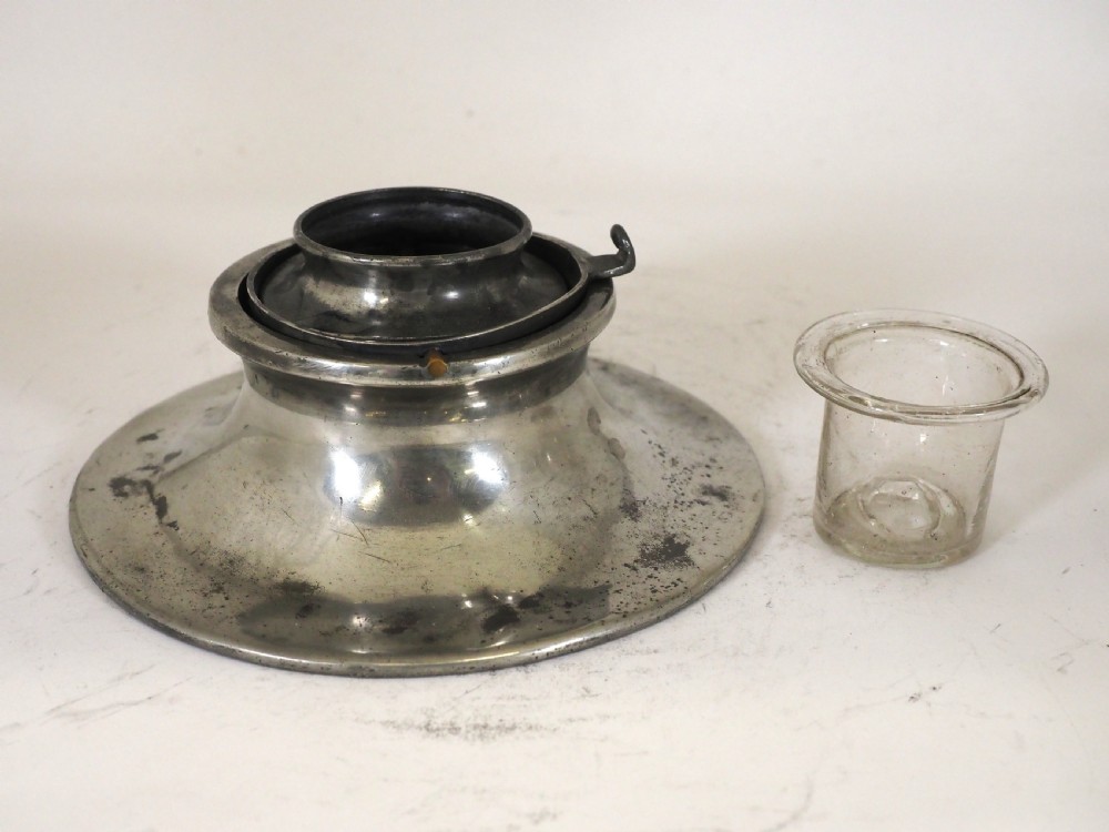 An antique pewter ships inkwell featuring a wide circular capstan base and a domed lid. View V