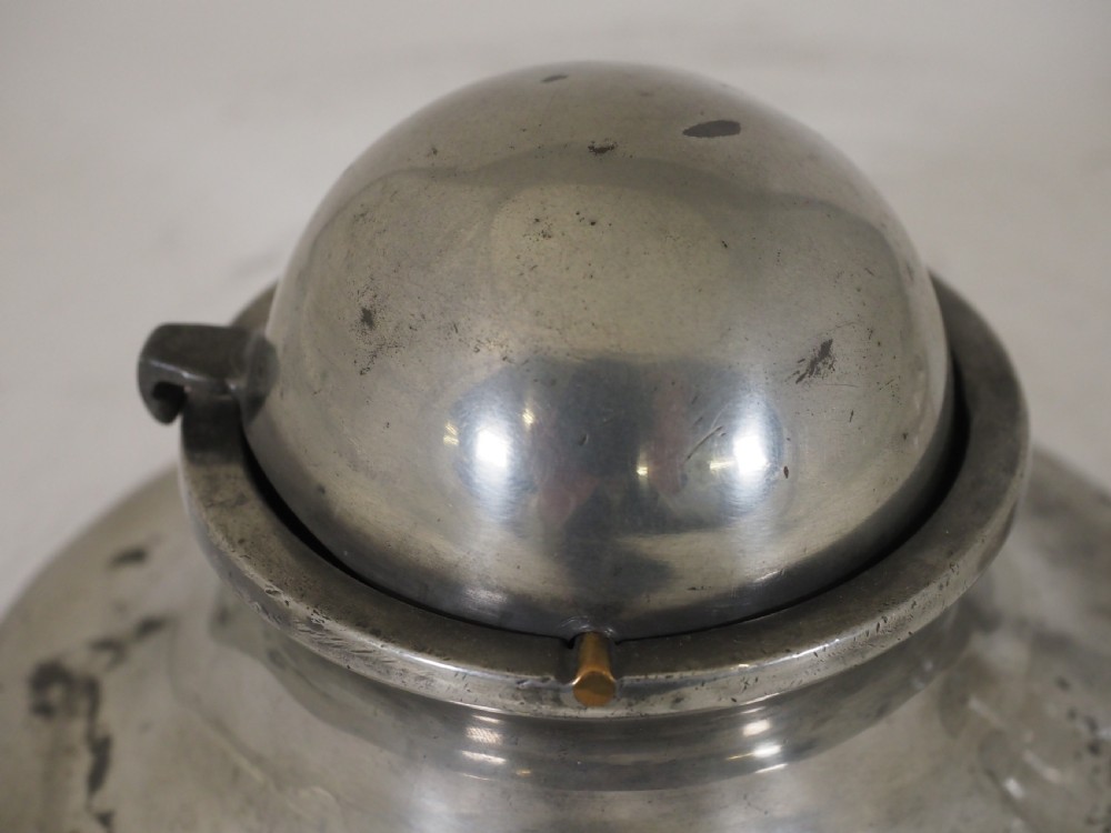 An antique pewter ships inkwell featuring a wide circular capstan base and a domed lid. View VII