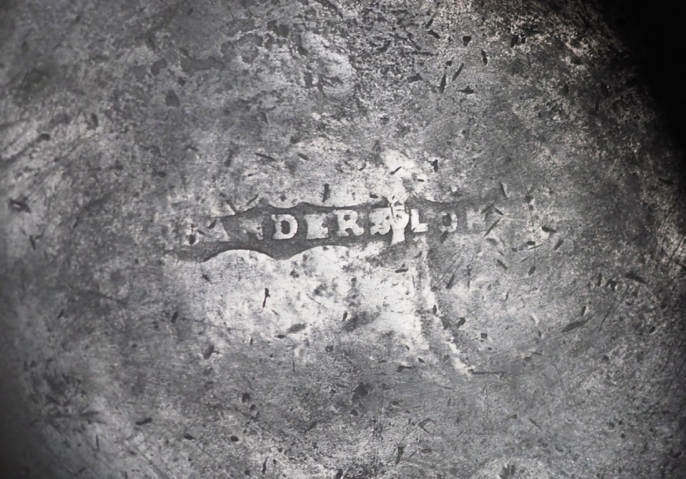 An antique grey pewter pint measure featuring a curved handle, cylindrical body with moulded bands, and engraved lettering on the side. View VIII