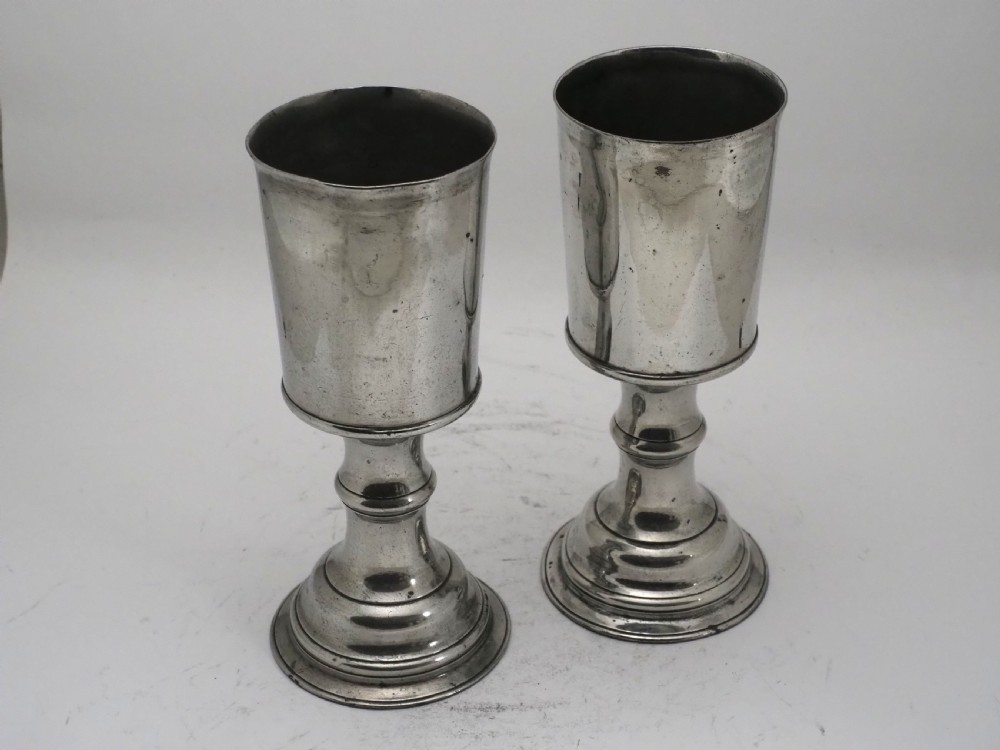 A pair of Georgian pewter chalices featuring cylindrical bowls, knopped stems, and stepped circular bases. View III