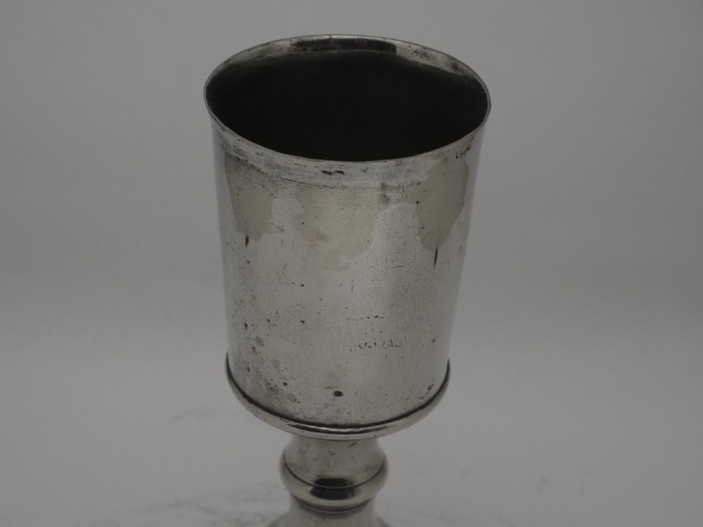 An 18th-century pewter chalice featuring a flared cylindrical cup, a turned central knopped stem, and a stepped circular spreading base. View IV