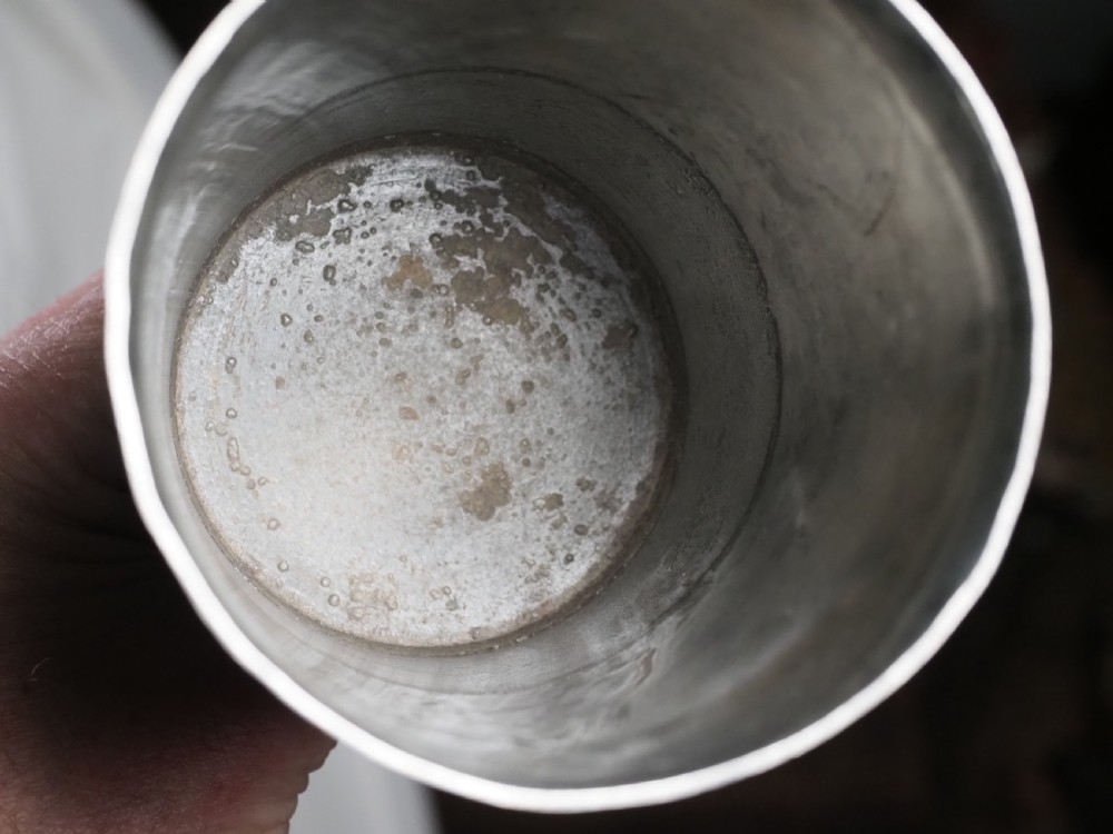 An 18th-century pewter chalice featuring a flared cylindrical cup, a turned central knopped stem, and a stepped circular spreading base. View V