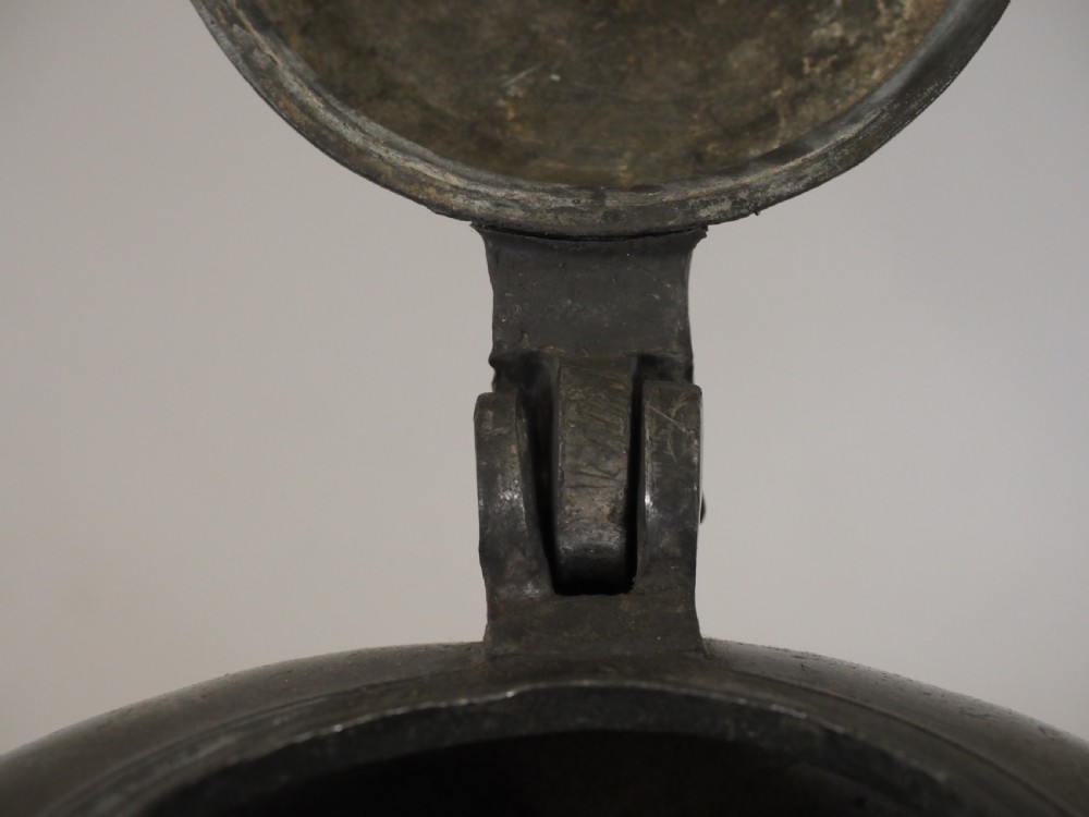 An antique 18th-century Swiss pewter biberon water vessel featuring a flared base, side spout with relief detailing, fitted lid, and tall wire handle. View VIII