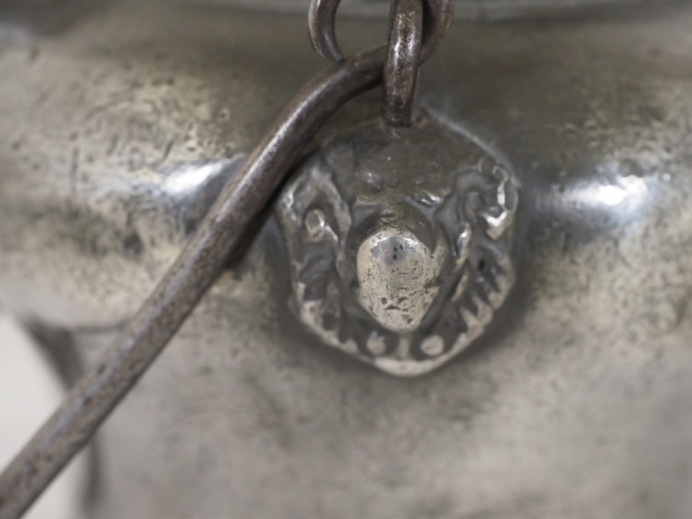 An antique 18th-century Swiss pewter biberon water vessel featuring a flared base, side spout with relief detailing, fitted lid, and tall wire handle. View XI