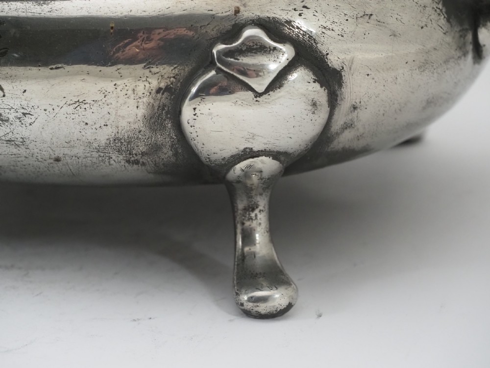 An antique Georgian pewter oval soup tureen featuring a domed lid with a loop handle, twin side handles, cabriole legs, and an engraved armorial crest. View IV