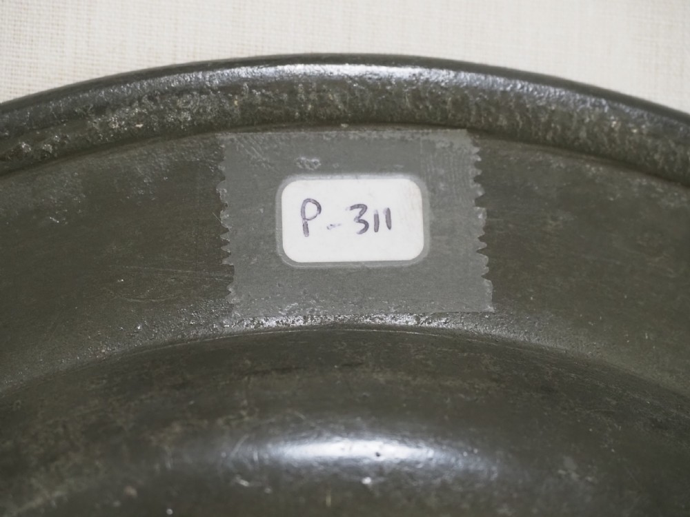 A circular antique pewter plate featuring a wide plain rim, a central shallow well, and subtle surface wear with a silver-grey patina. View VIII