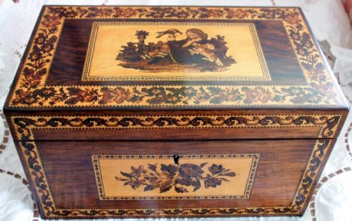fig 1. A rectangular Victorian rosewood tea caddy featuring intricate Tunbridge ware mosaic borders and a central pictorial inlay on the hinged lid.
