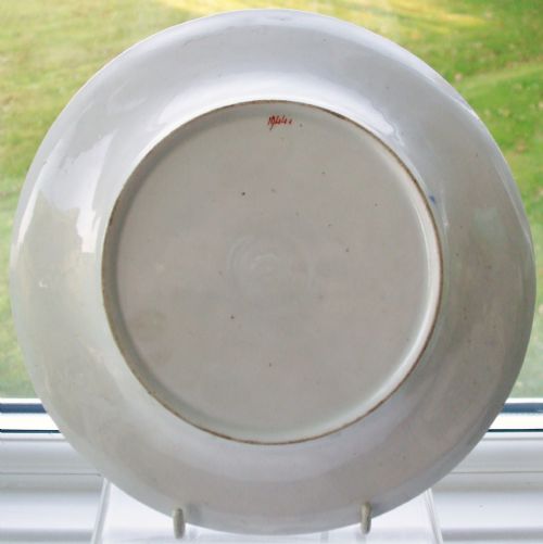 fig 1. A circular Georgian New Hall porcelain dish featuring a cobalt blue gilded border and hand-painted polychrome floral motifs on a white moulded ground.