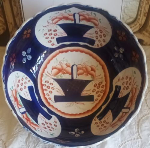 fig 1. An antique Victorian Gaudy Welsh footed earthenware bowl decorated with cobalt blue, rust-orange basket of flowers motifs, and copper lustre details.