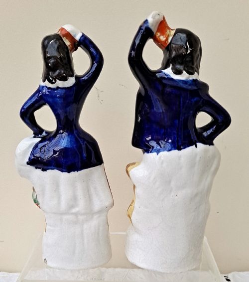 fig 2. A pair of Victorian Staffordshire earthenware figures depicting a male sailor and a female companion wearing cobalt blue jackets.