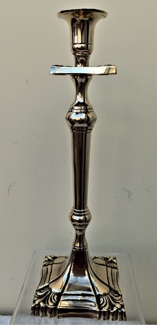 fig 1. A tall Victorian polished brass candlestick featuring a square moulded base with foliage motifs, a knopped baluster stem, and a splayed sconce.