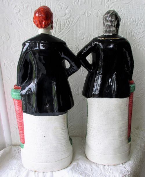 fig 2. A pair of antique Victorian Staffordshire earthenware portrait figures depicting Moody and Sankey standing beside red pillars with moulded bases.