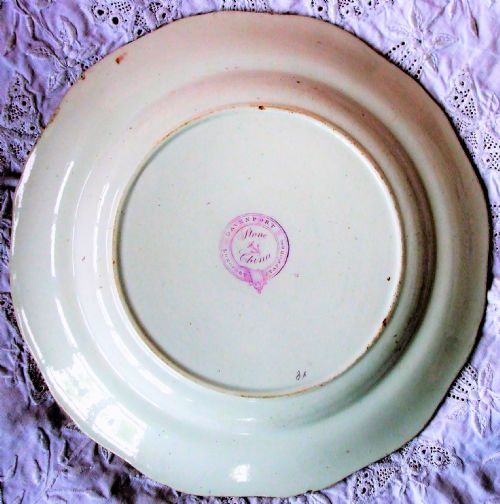 fig 1. Octagonal Georgian English ironstone plate decorated with a hand-painted Imari style floral motif in cobalt blue, rust orange, and green on an off-white glaze background.