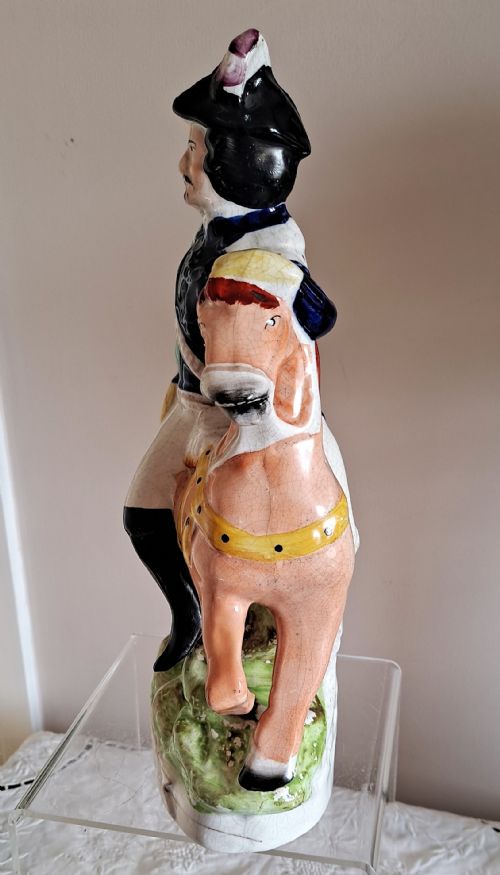 fig 2. A pair of Victorian Staffordshire ceramic equestrian figures depicting Louis Napoleon and the Empress of France mounted on chestnut horses with blue and green details.
