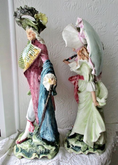 fig 1. A pair of hand-painted French faience ceramic figurines depicting an 18th-century gentleman and a lady holding a parasol.