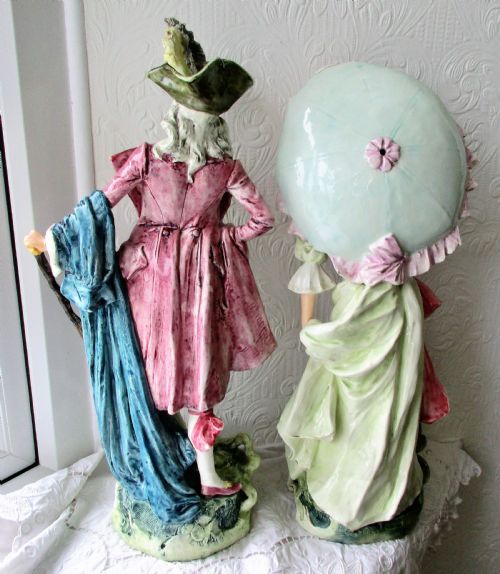 fig 2. A pair of hand-painted French faience ceramic figurines depicting an 18th-century gentleman and a lady holding a parasol.