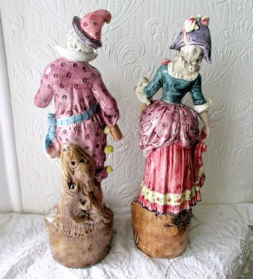 fig 2. A pair of hand-painted French earthenware figurines depicting a male and female figure in carnival attire with rose pink and teal glazes.