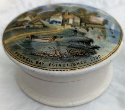 fig 1. A round Victorian earthenware Prattware pot lid depicting a printed coastal scene of Pegwell Bay with the Bellevue inn and surrounding landscape.