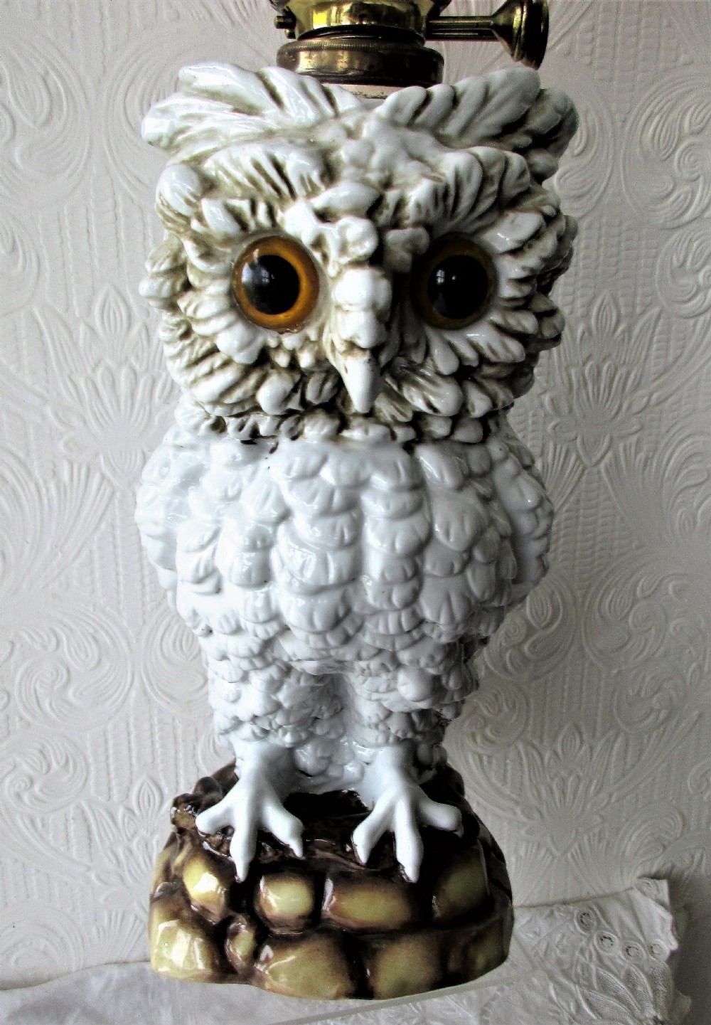 An antique Victorian Sitzendorf oil lamp featuring a sculpted white glazed porcelain owl base with glass eyes, brass burner, clear glass chimney, and a flared, etched pink glass shade. View II