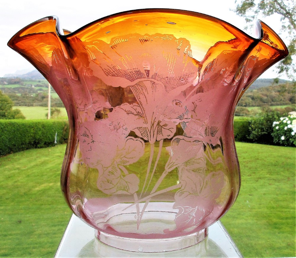 An antique Victorian Sitzendorf oil lamp featuring a sculpted white glazed porcelain owl base with glass eyes, brass burner, clear glass chimney, and a flared, etched pink glass shade. View V