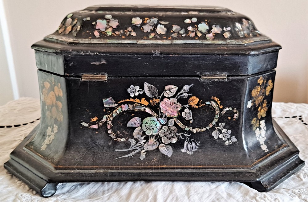 A Victorian black papier-mache tea caddy with mother-of-pearl floral inlay and painted gilt details. View III