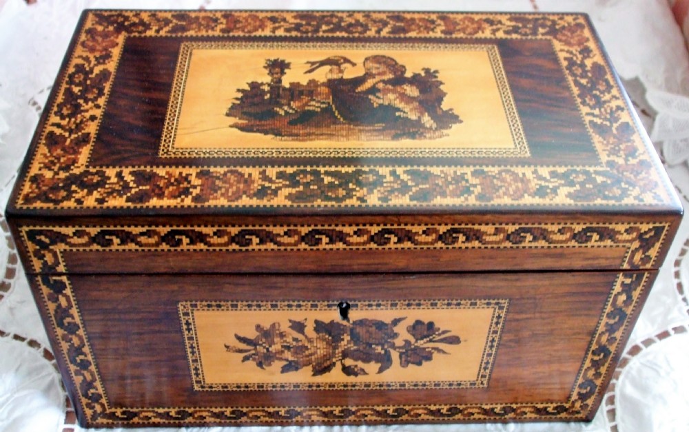 A rectangular Victorian rosewood tea caddy featuring intricate Tunbridge ware mosaic borders and a central pictorial inlay on the hinged lid. View II