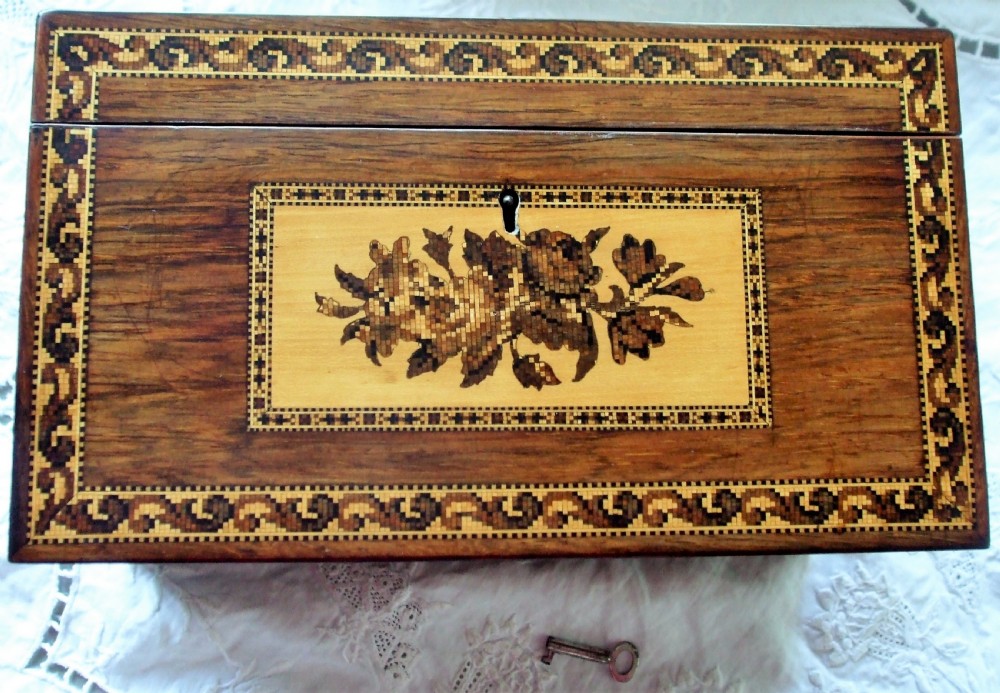 A rectangular Victorian rosewood tea caddy featuring intricate Tunbridge ware mosaic borders and a central pictorial inlay on the hinged lid. View VII