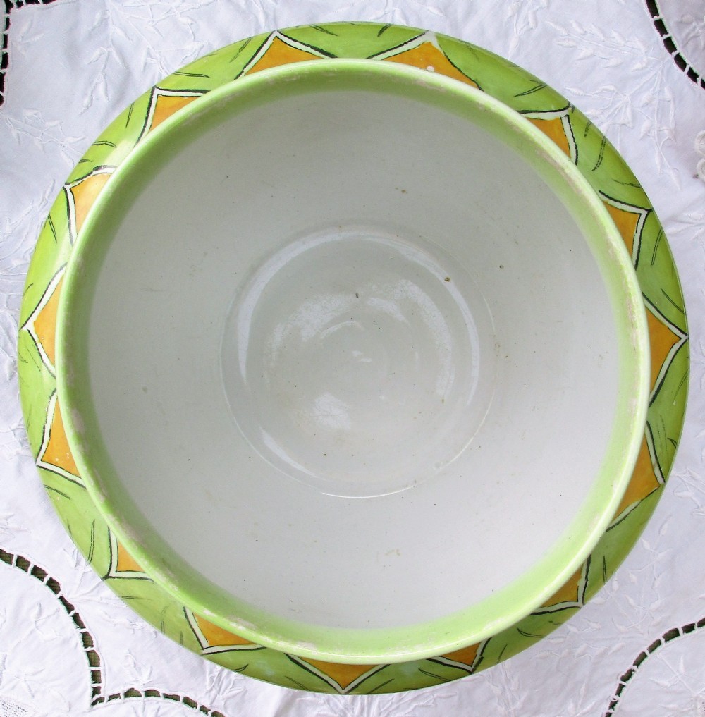An antique Art Nouveau glazed ceramic jardiniere featuring a vibrant green ground decorated with stylized botanical leaf motifs and yellow accents. View IV