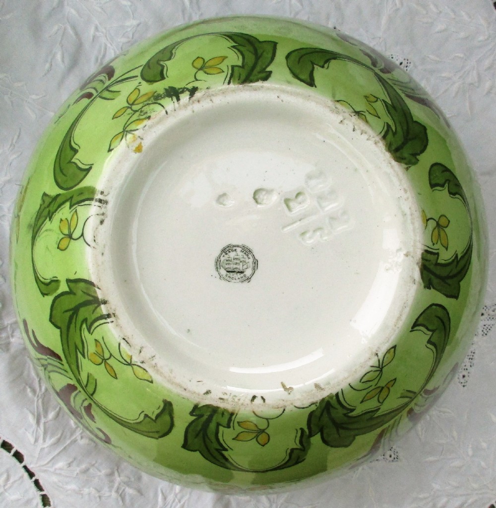 An antique Art Nouveau glazed ceramic jardiniere featuring a vibrant green ground decorated with stylized botanical leaf motifs and yellow accents. View VII