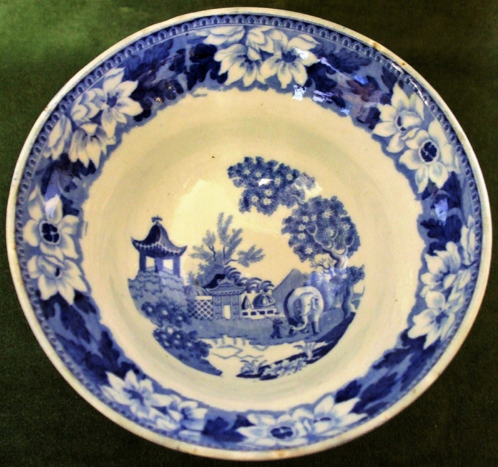 An antique blue and white transfer-printed earthenware tureen featuring a pedestal base, floral patterns, and a fitted lid with a molded animal finial. View V