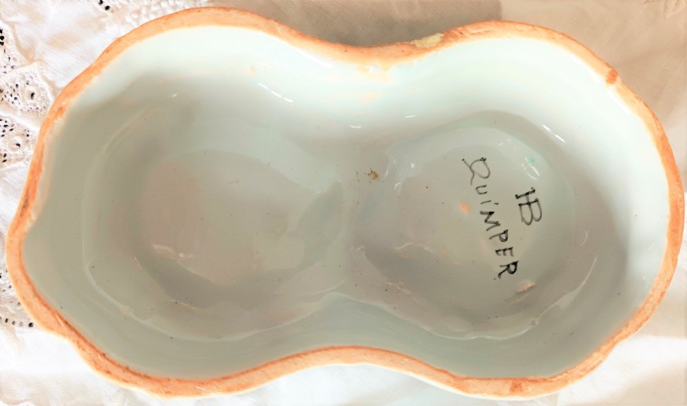 A double salt cellar made of pale blue tin-glazed ceramic with hand-painted floral motifs in blue, green, and orange. View III