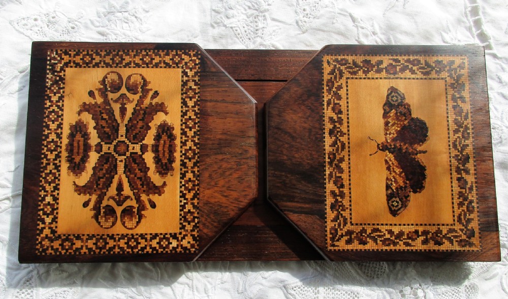 An antique Victorian expanding rosewood book slide decorated with Tunbridge ware marquetry panels depicting a scroll pattern and a moth.