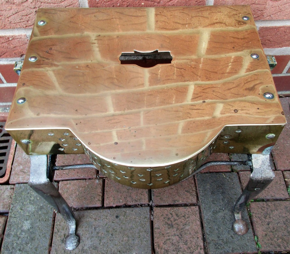 An antique Georgian brass and steel fireplace footman stand with a pierced lattice apron, cabriole front legs, and top carrying handle. View II