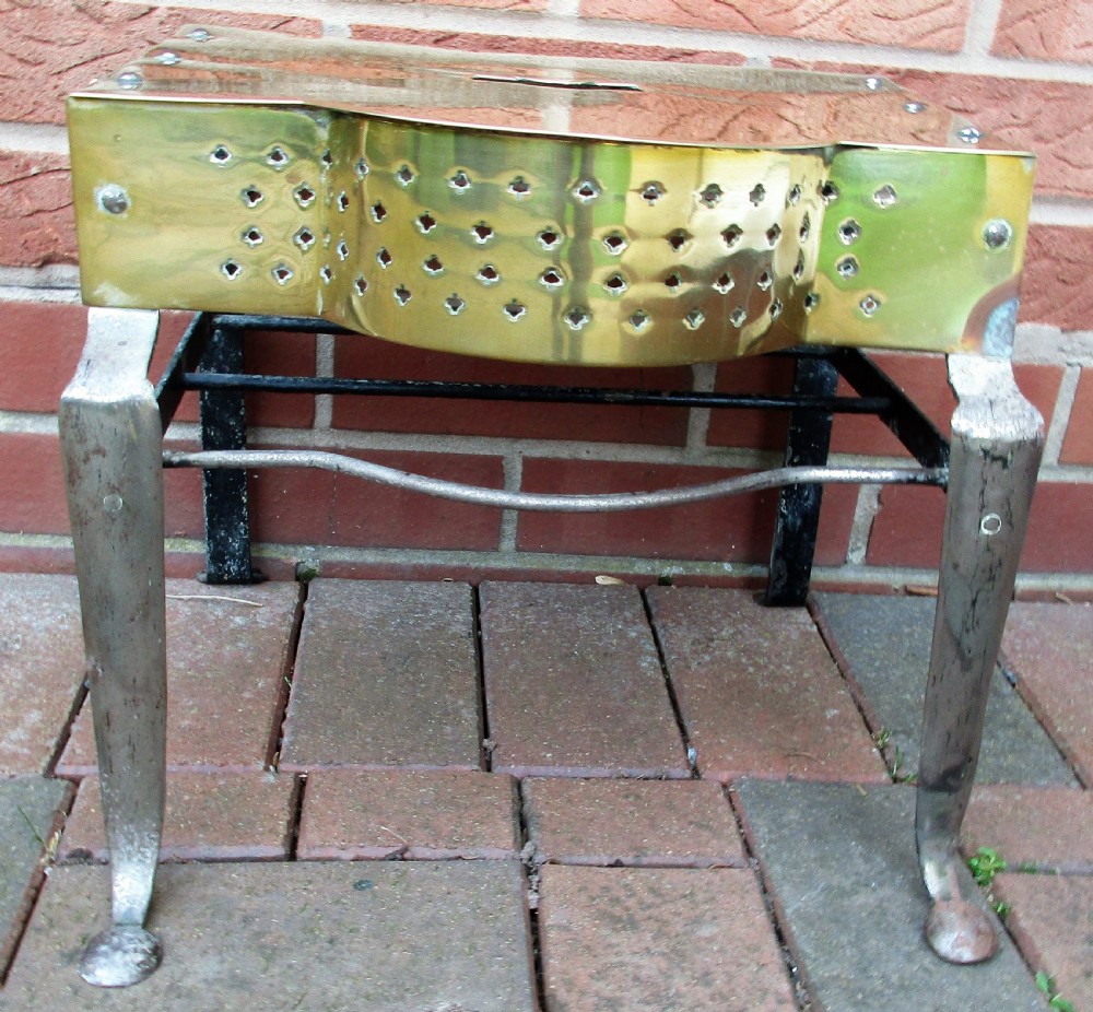 An antique Georgian brass and steel fireplace footman stand with a pierced lattice apron, cabriole front legs, and top carrying handle. View VI
