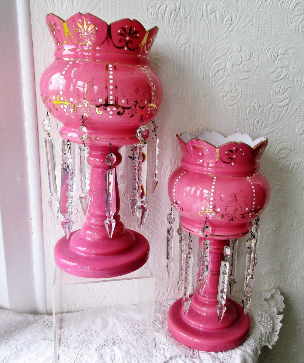 A pair of Victorian pink glass lustres decorated with gilded scrolling, enamel dots, scalloped rims, and suspended clear cut-glass prisms. View V