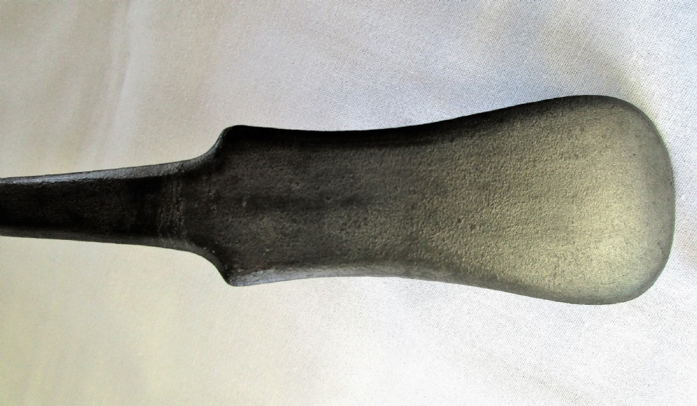 An antique Georgian pewter ladle featuring a rounded deep bowl and a long flattened handle stem. View V