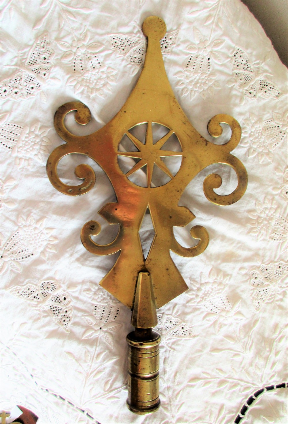 An antique Victorian cast brass friendly society pole head featuring a central star motif within a circular cut-out surrounded by pierced scrollwork and a hollow mounting socket at the base.